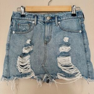 Distressed denim mini skirt